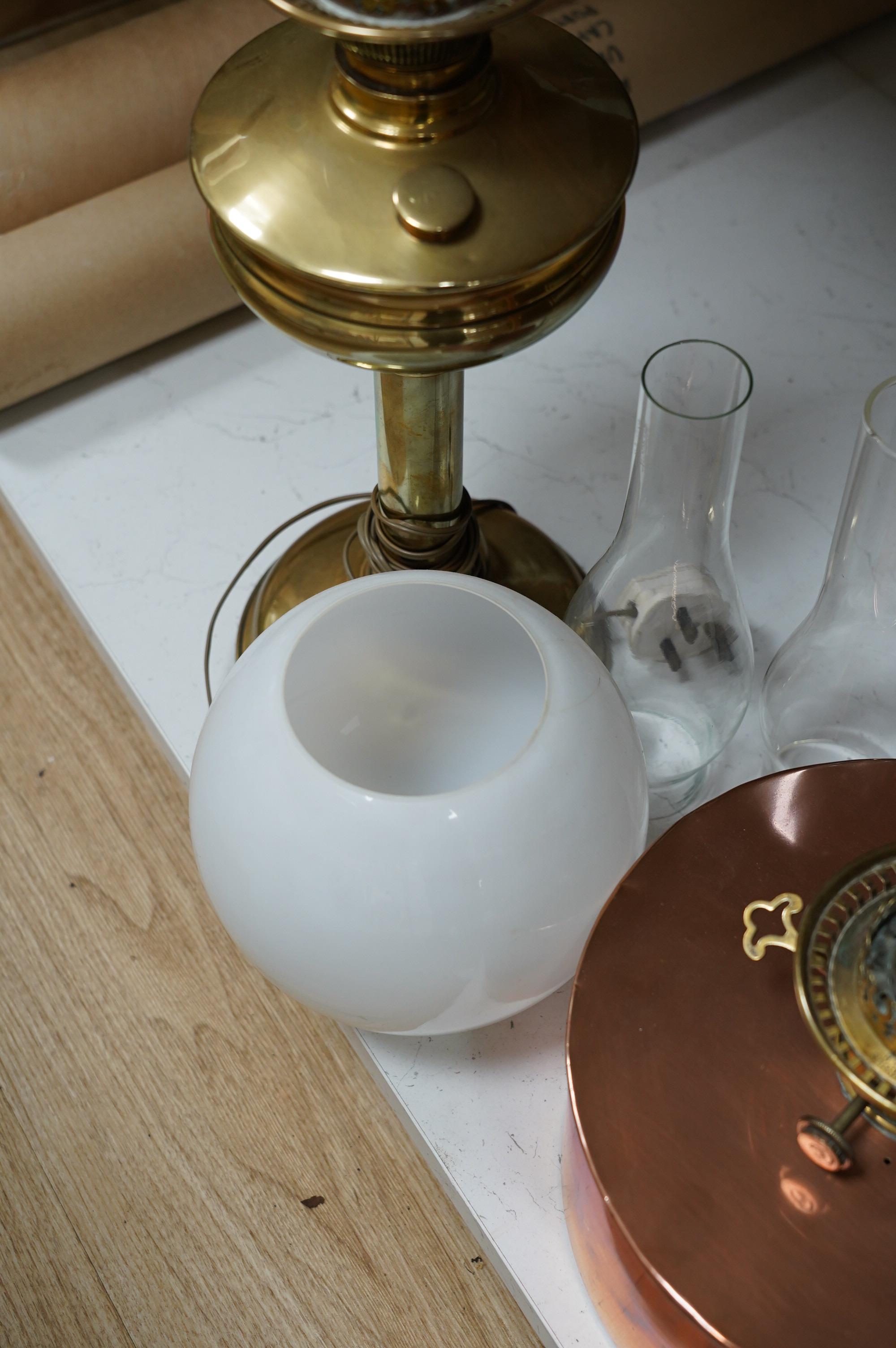 Two oil lamps to include a brass example with opaque glass shade. Condition - fair to good